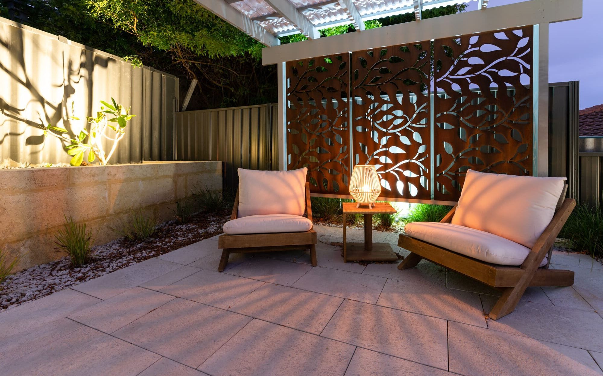 pergola and outdoor seating lit up with garden lighting
